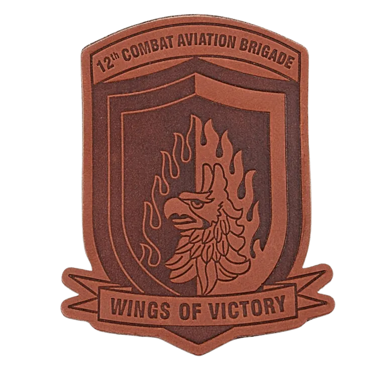 Close up image of an embroidered patch with trees and pink background