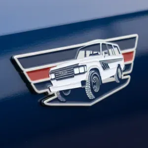 Custom metal Ford Bronco vehicle emblem with enamel color fill displayed on car