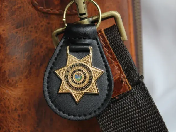 Custom leather and metal keychain with sheriff star badge emblem